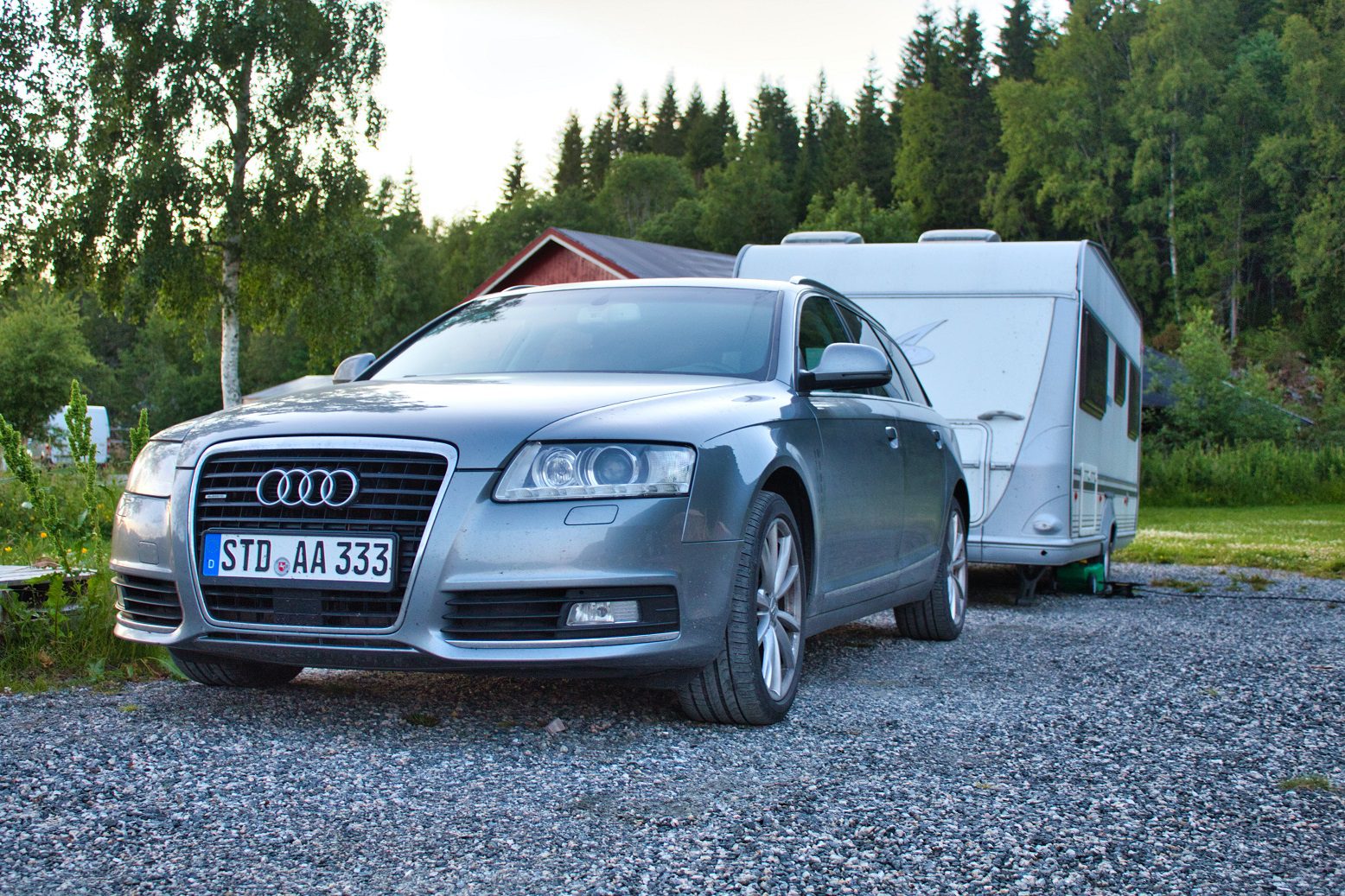 Caravan hitched to a grey audi.
