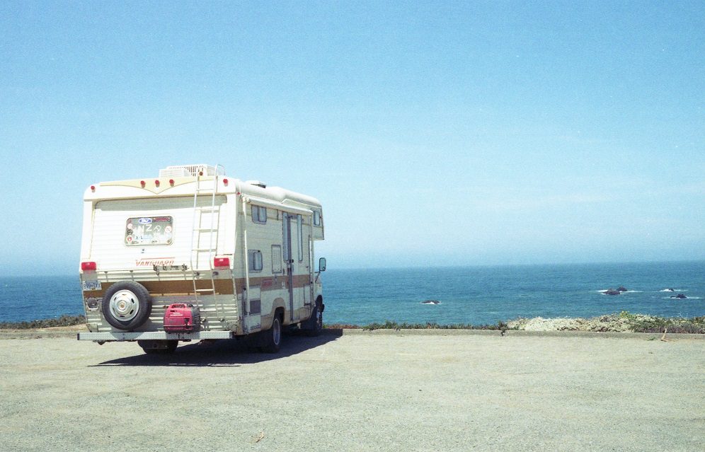 Caravan parked at a lookout with an ocean view.